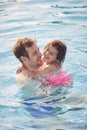 Laughing Father And Daughter Having Fun In Swimming Pool On Summer Vacation