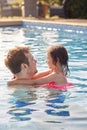 Laughing Father And Daughter Having Fun In Swimming Pool On Summer Vacation