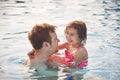 Laughing Father And Daughter Having Fun In Swimming Pool On Summer Vacation