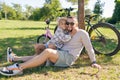 Laughing father and his daughter having fun together at the green park, relax and have fun together after cycling Royalty Free Stock Photo