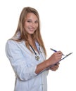 Laughing female doctor with blond hair and clipboard Royalty Free Stock Photo
