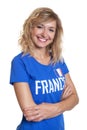 Laughing french sports with blond hair and blue jersey Royalty Free Stock Photo