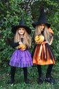 Laughing funny child girls in a witch costume in halloween outdoor