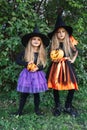 Laughing funny child girls in a witch costume in halloween outdoor