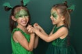 Laughing funny children with makeup in the guise of a dragon play together