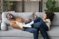 Laughing funny father play with daughter lying on sofa Royalty Free Stock Photo