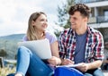 Laughing german student couple with computer Royalty Free Stock Photo