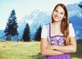 Laughing german woman in bavarian dirndl with rural landscape