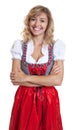 Laughing german woman with crossed arms in a traditional bavarian dirndl Royalty Free Stock Photo