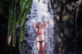 Laughing girl bathing in the forest waterfall Royalty Free Stock Photo