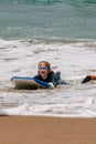 Laughing Girl On Boogie Board Washed Up On Beach Royalty Free Stock Photo