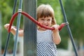 Laughing girl climbing at ropes