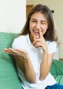 Laughing girl with finger in nose