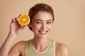 Laughing Girl Hold Slices of Orange. Happy Woman Recommended Vitamin for Skin