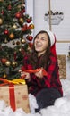 Laughing girl near Christmas gift positive emotion portrait photography vertical format concept in winter holidays