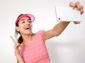 Laughing girl with peace hand sign taking selfie Royalty Free Stock Photo
