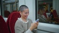 Laughing girl reading message on cell phone travelling modern train close up. Royalty Free Stock Photo