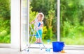 Laughing girl washing a window Royalty Free Stock Photo