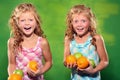 Laughing girls holding some fruit