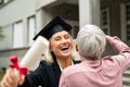 Laughing graduate student embracing mother Royalty Free Stock Photo