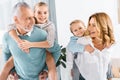 laughing grandparents doing piggyback ride to adorable grandchildren Royalty Free Stock Photo