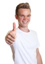 Laughing guy with blond hair showing thumb