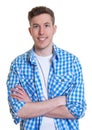 Laughing guy in a checked shirt with crossed arms Royalty Free Stock Photo