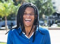 Laughing guy with dreadlocks in the city Royalty Free Stock Photo