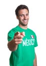 Laughing guy in a mexican jersey pointing at camera Royalty Free Stock Photo