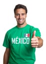 Laughing guy in a mexican jersey showing thumb up Royalty Free Stock Photo