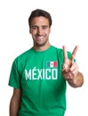 Laughing guy in a mexican jersey showing victory sign Royalty Free Stock Photo