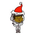 laughing hand drawn comic book style illustration of a astronaut wearing santa hat