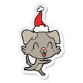 laughing hand drawn sticker cartoon of a dog wearing santa hat