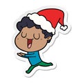 laughing hand drawn sticker cartoon of a man running wearing santa hat