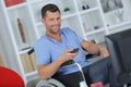 Laughing handicapped man watching television in living room