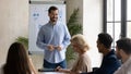 Laughing handsome businessman flip charts presentation new project in boardroom.