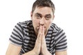 Laughing handsome young man folded his hands in prayer, close-up Royalty Free Stock Photo