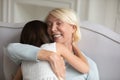 50s grandmother embracing granddaughter enjoy moment of tenderness Royalty Free Stock Photo