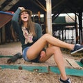 Laughing hipster girl portrait under the old pier on a sea beach. Royalty Free Stock Photo