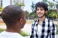 Laughing hipster man talking with african american friend Royalty Free Stock Photo