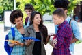 Laughing hispanic female student learning with group of latin and african american young adults Royalty Free Stock Photo