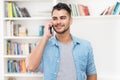 Laughing hispanic hipster man in quarantine talking at mobile phone Royalty Free Stock Photo