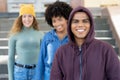 Laughing hispanic man with african american and caucasian friends in a row Royalty Free Stock Photo