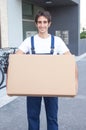 Laughing hispanic worker with box