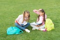 Laughing from joke. having fun on green grass. two little kids with backpack. small girl play and study on school break Royalty Free Stock Photo