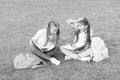 Laughing from joke. having fun on green grass. two little kids with backpack. small girl play and study on school break Royalty Free Stock Photo