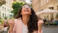 Laughing joke toothy smiling cheerful happy woman Indian Arabian female girl lady outside street town. Joyful hope