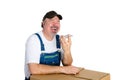 Laughing jovial worker using a speaker phone Royalty Free Stock Photo