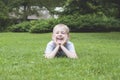 Laughing kid on a green grass Royalty Free Stock Photo