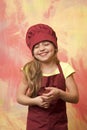 Laughing kid, happy girl cook in red chef hat, apron Royalty Free Stock Photo
